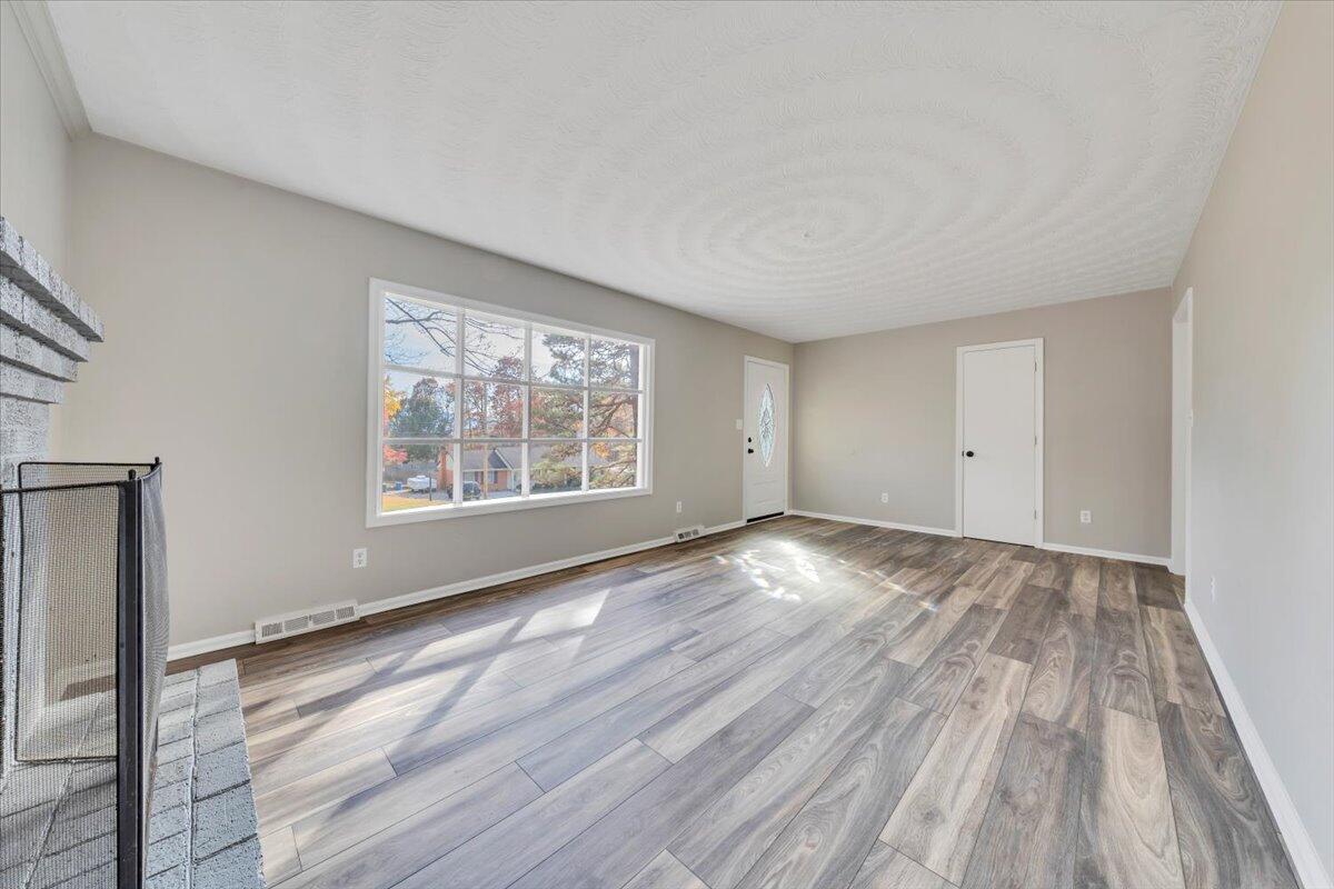 222 Maple Drive Blue Ridge, VA 24064 - Photo 12 of 24 wooden floor in an empty room with a window