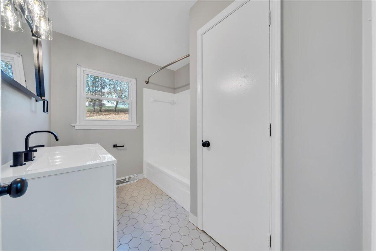 222 Maple Drive Blue Ridge, VA 24064 - Photo 14 of 24 a room with a sink a washer and dryer