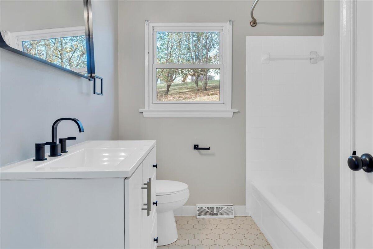 222 Maple Drive Blue Ridge, VA 24064 - Photo 15 of 24 a bathroom with a sink a toilet and a window