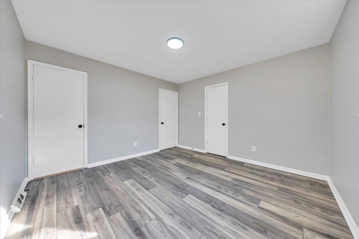 222 Maple Drive Blue Ridge, VA 24064 - Photo 17 of 24 a view of empty room with wooden floor and fan