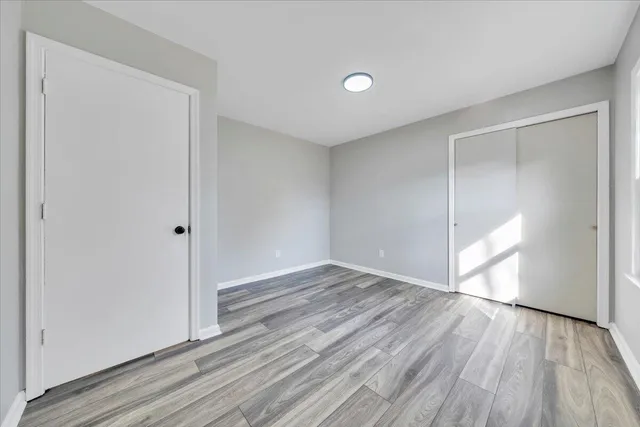 a view of an empty room and wooden floor