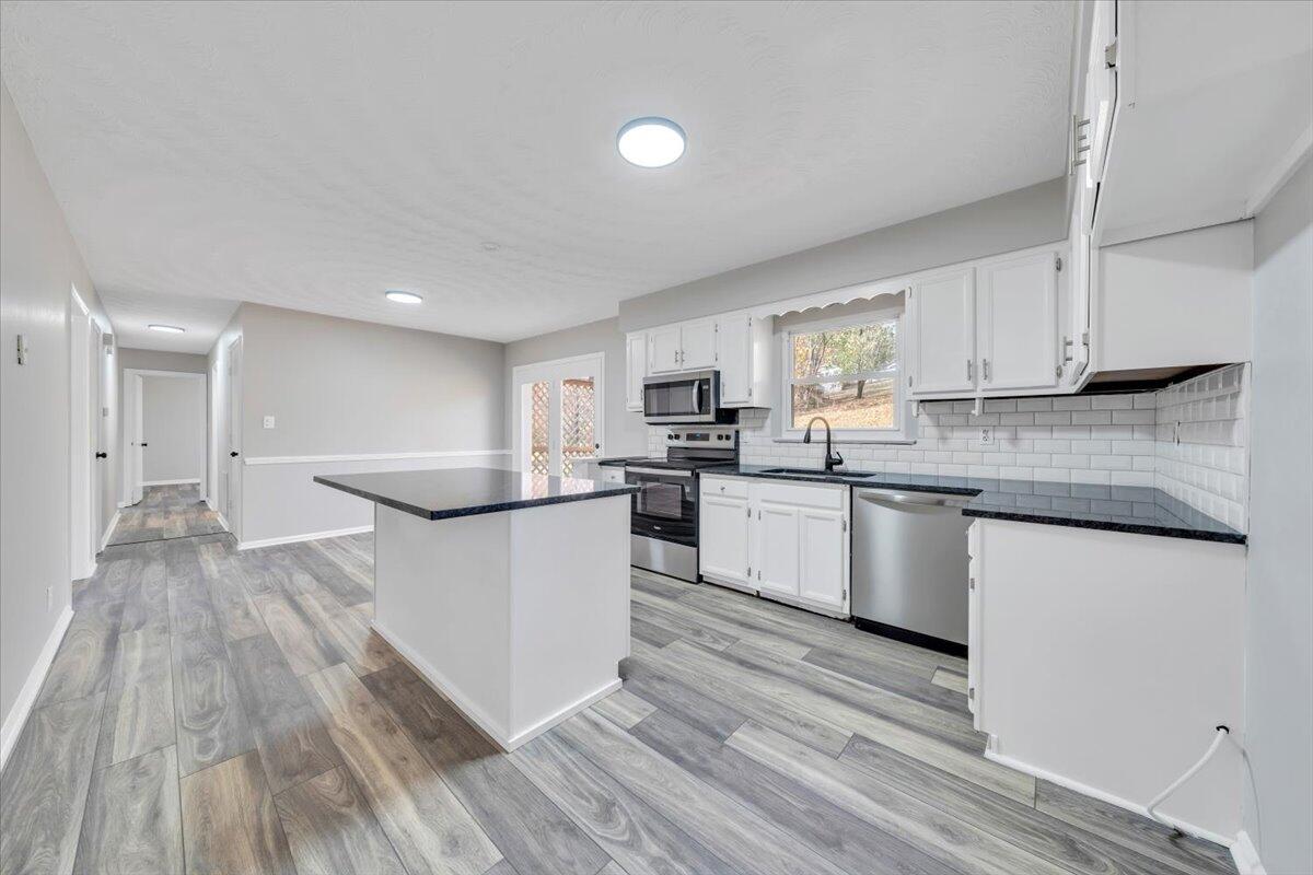 222 Maple Drive Blue Ridge, VA 24064 - Photo 7 of 24 a kitchen with granite countertop a stove top oven sink and cabinets