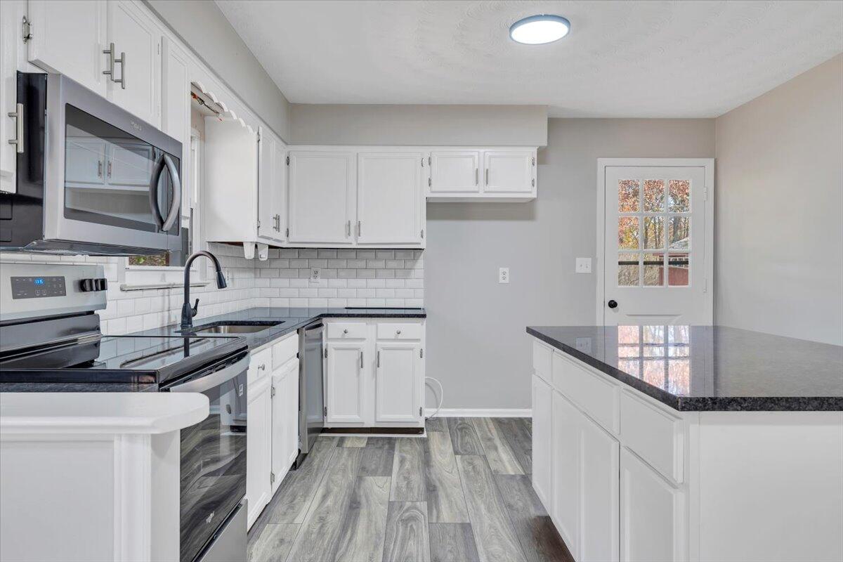 222 Maple Drive Blue Ridge, VA 24064 - Photo 8 of 24 a kitchen with stainless steel appliances granite countertop a sink stove and cabinets