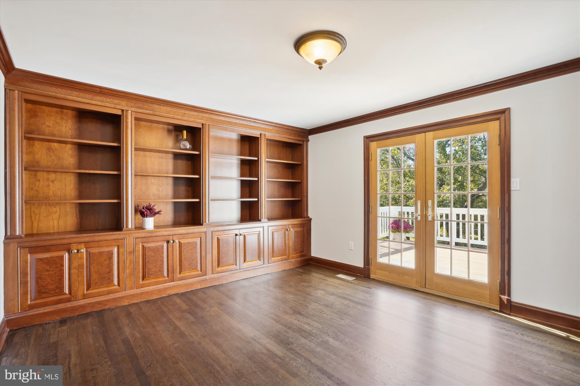 646 Seneca Road Great Falls, VA 22066 - Photo 13 of 52 Tasteful built ins and french doors to deck.
