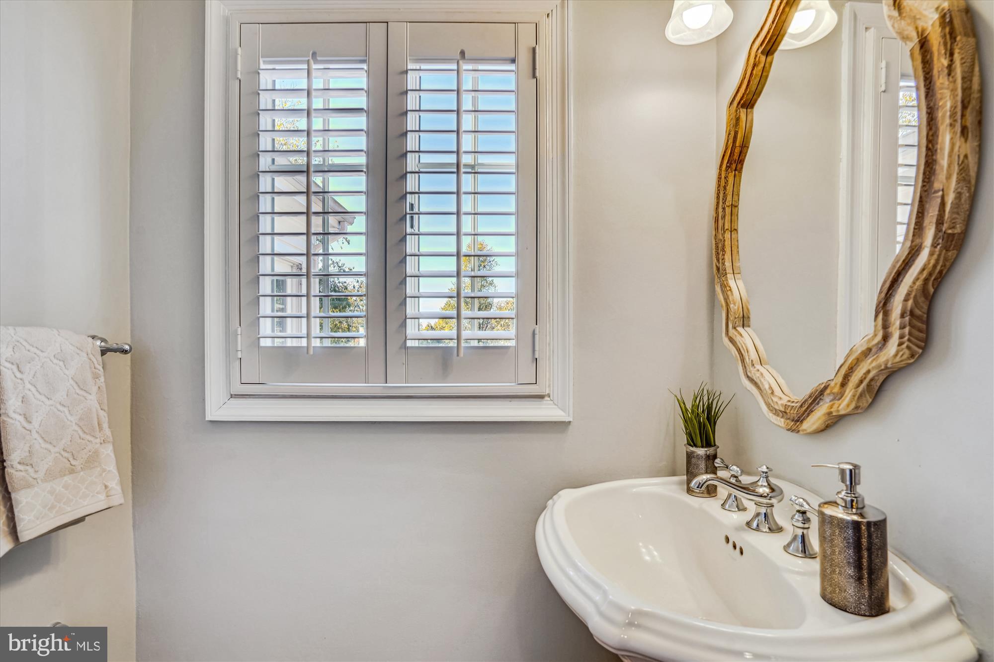 646 Seneca Road Great Falls, VA 22066 - Photo 17 of 52 Convenient powder room with plantation shutters.