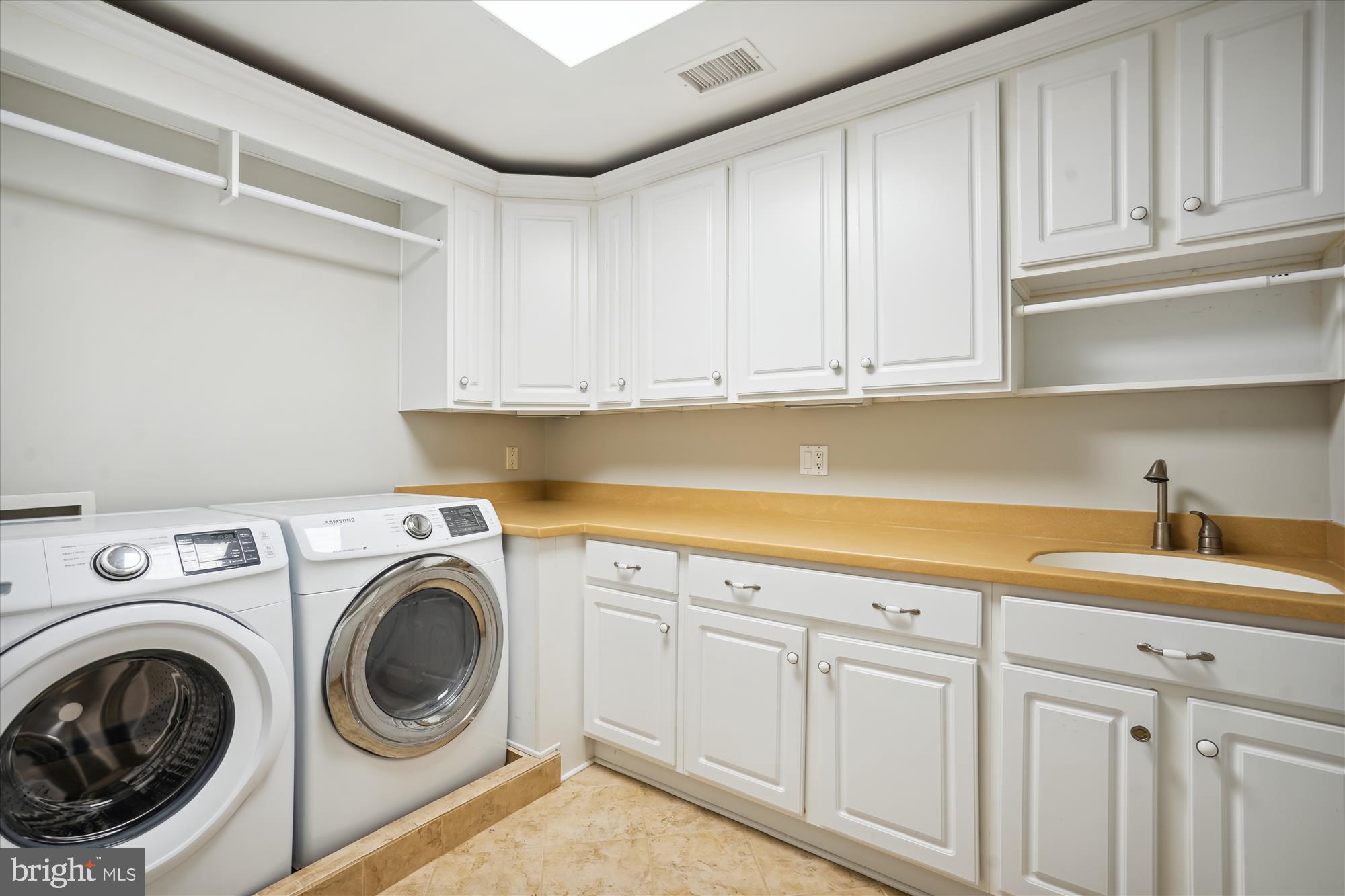 646 Seneca Road Great Falls, VA 22066 - Photo 30 of 52 Upstairs laundry room with cabinet storage.