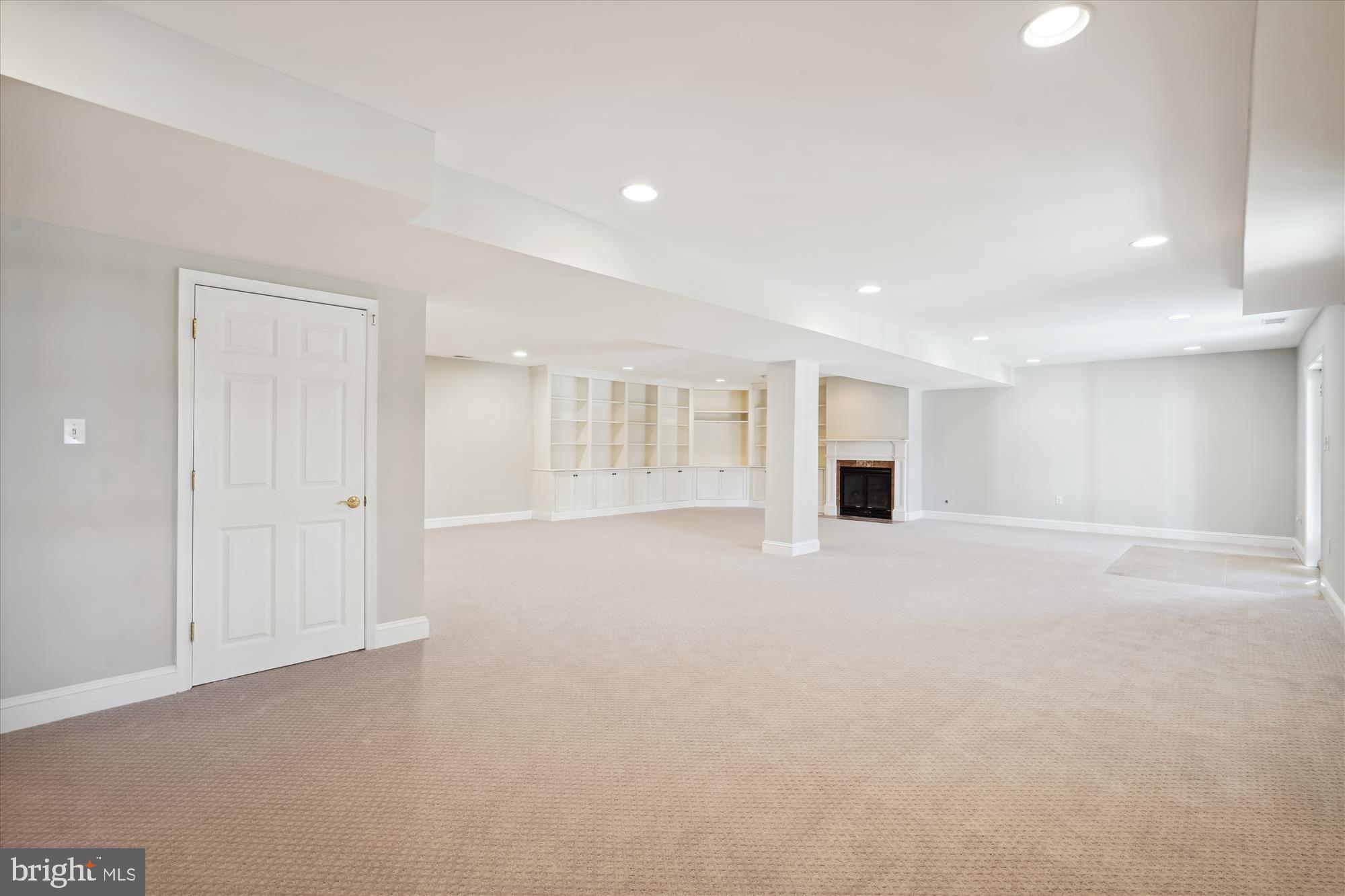 646 Seneca Road Great Falls, VA 22066 - Photo 31 of 52 Recreation room with bookshelves & fireplace.