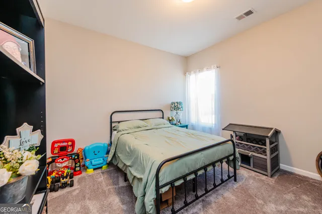 a bedroom with a bed and a tv