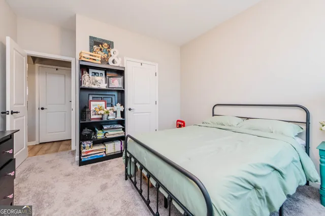 a bedroom with a bed and cabinets