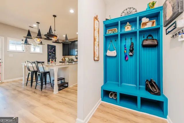 a dining room with furniture and wooden floor