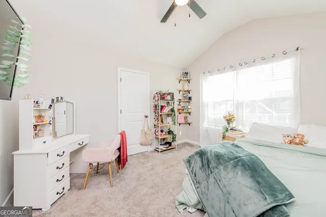 a bedroom with furniture and a large window