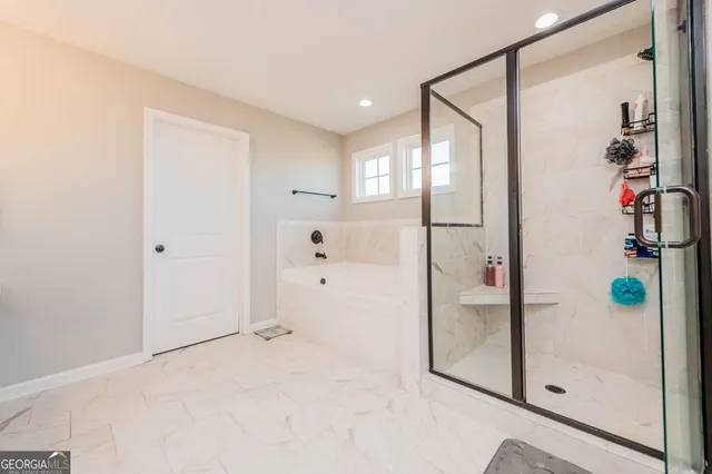 a spacious bathroom with a tub sink and mirror