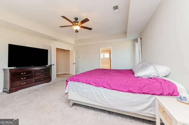 a kitchen with stainless steel appliances kitchen island a refrigerator and a wooden floor