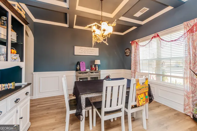 a view of a dining room with furniture and chandelier