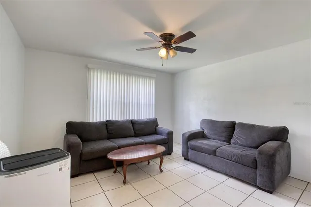 a living room with furniture a rug and a window