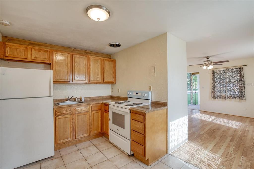 815 8th Street Daytona Beach, FL 32117 - Photo 25 of 50 a kitchen with a stove a sink and a refrigerator