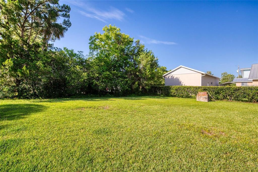 815 8th Street Daytona Beach, FL 32117 - Photo 37 of 50 a view of a large yard with an outdoor space and seating area