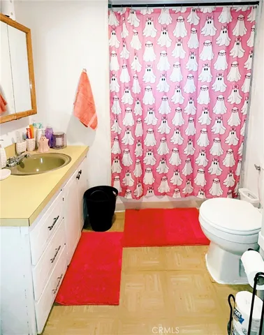 a bathroom with a sink vanity mirror and toilet