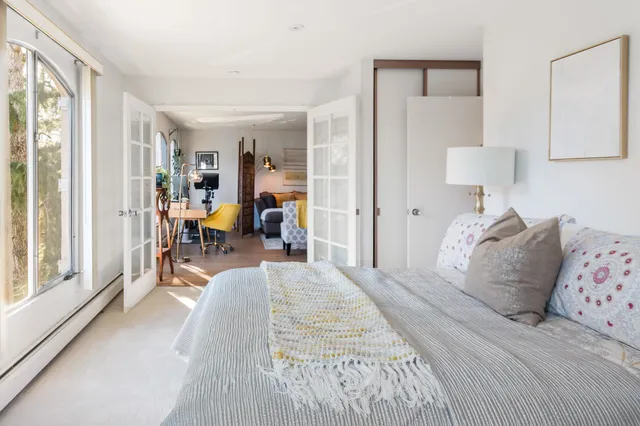 a bed room with a bed and a large mirror