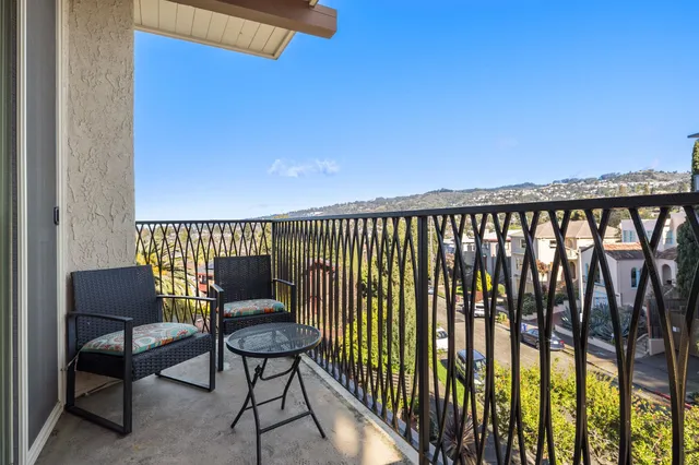 a balcony with a water view and chairs