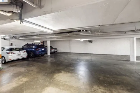 a view of parking garage with cars parked