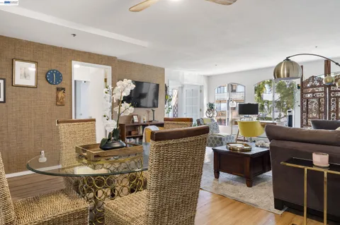 a living room with furniture a flat screen tv and a table