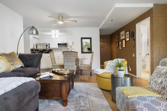 a living room with furniture and wooden floor