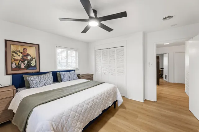 a bedroom with a bed and a window