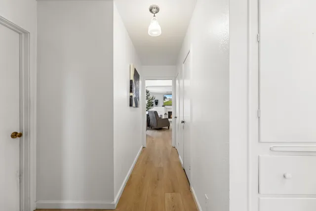 a living room with furniture a fireplace and a large window