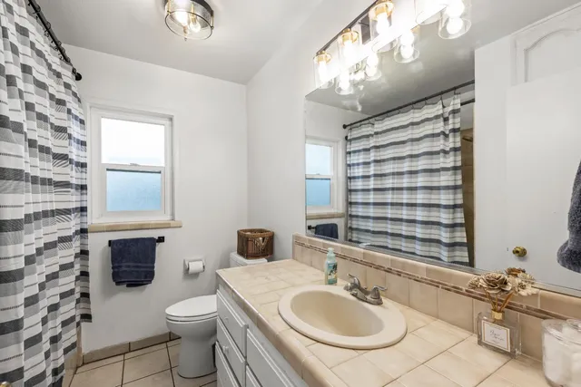 a view of a hallway with wooden floor and a living room