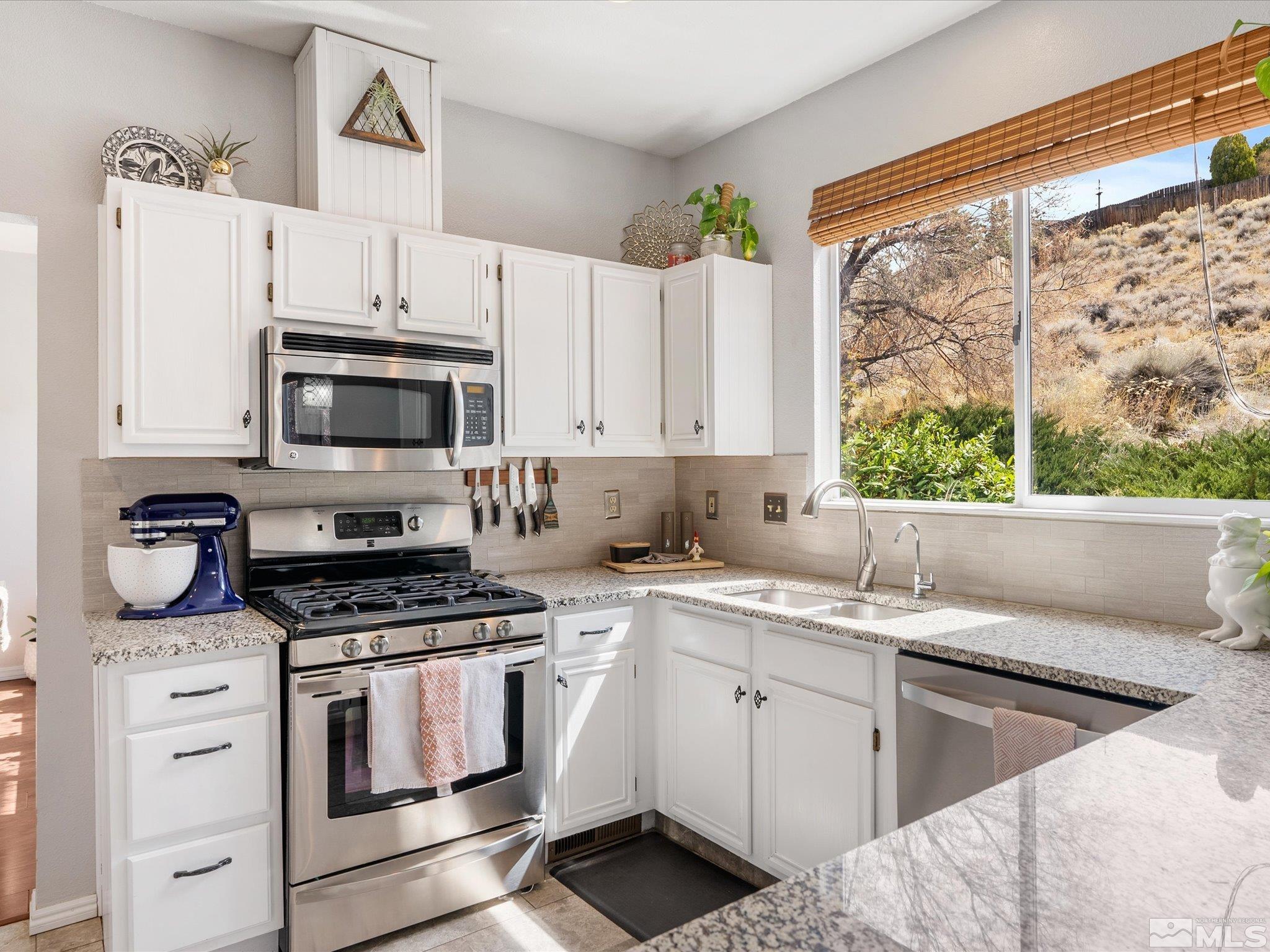 2946 Aspendale Drive Reno, NV 89503 - Photo 11 of 40 a kitchen with cabinets appliances a sink and a window