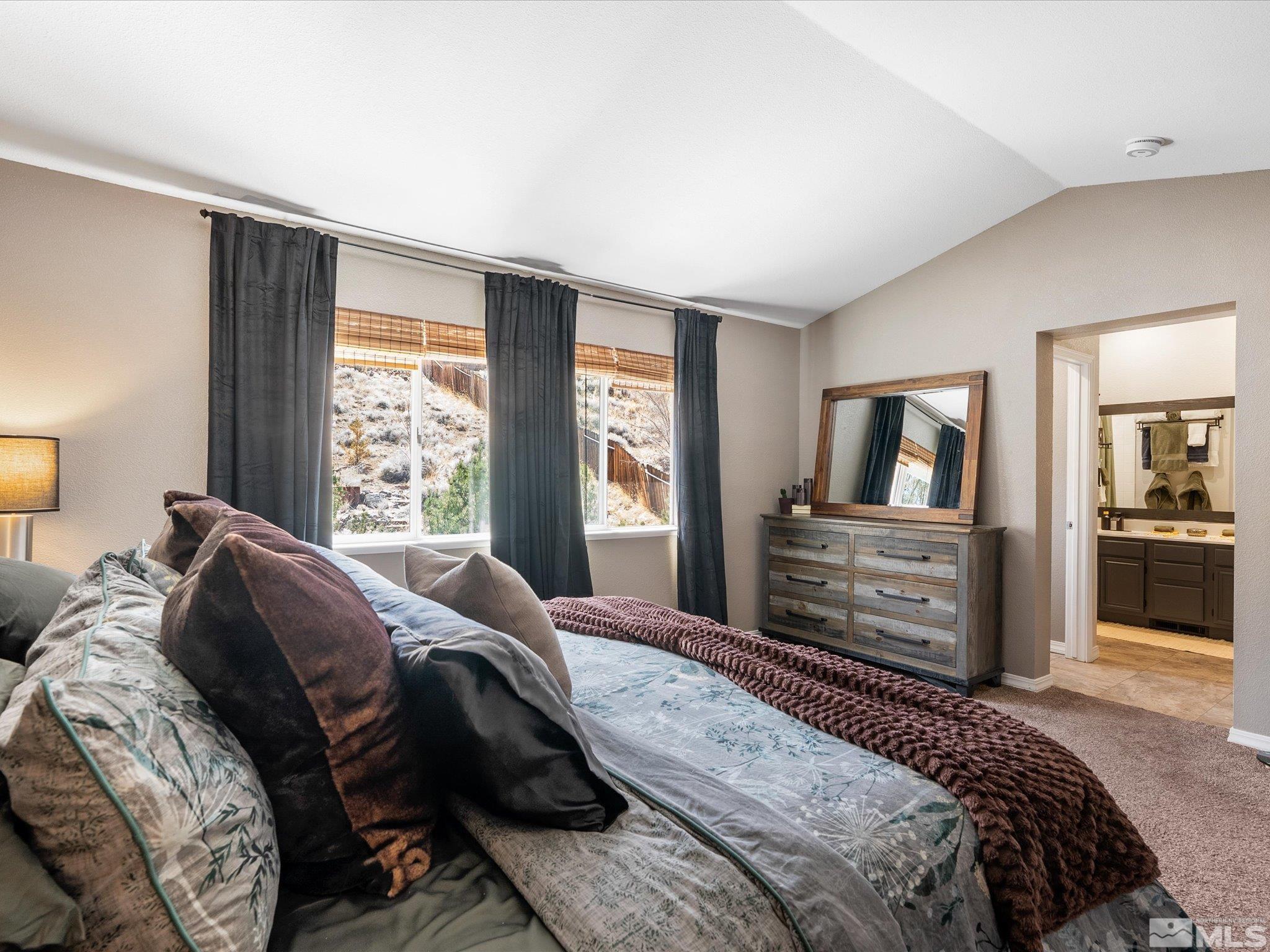 2946 Aspendale Drive Reno, NV 89503 - Photo 15 of 40 a bedroom with a large bed a flat tv screen and dresser