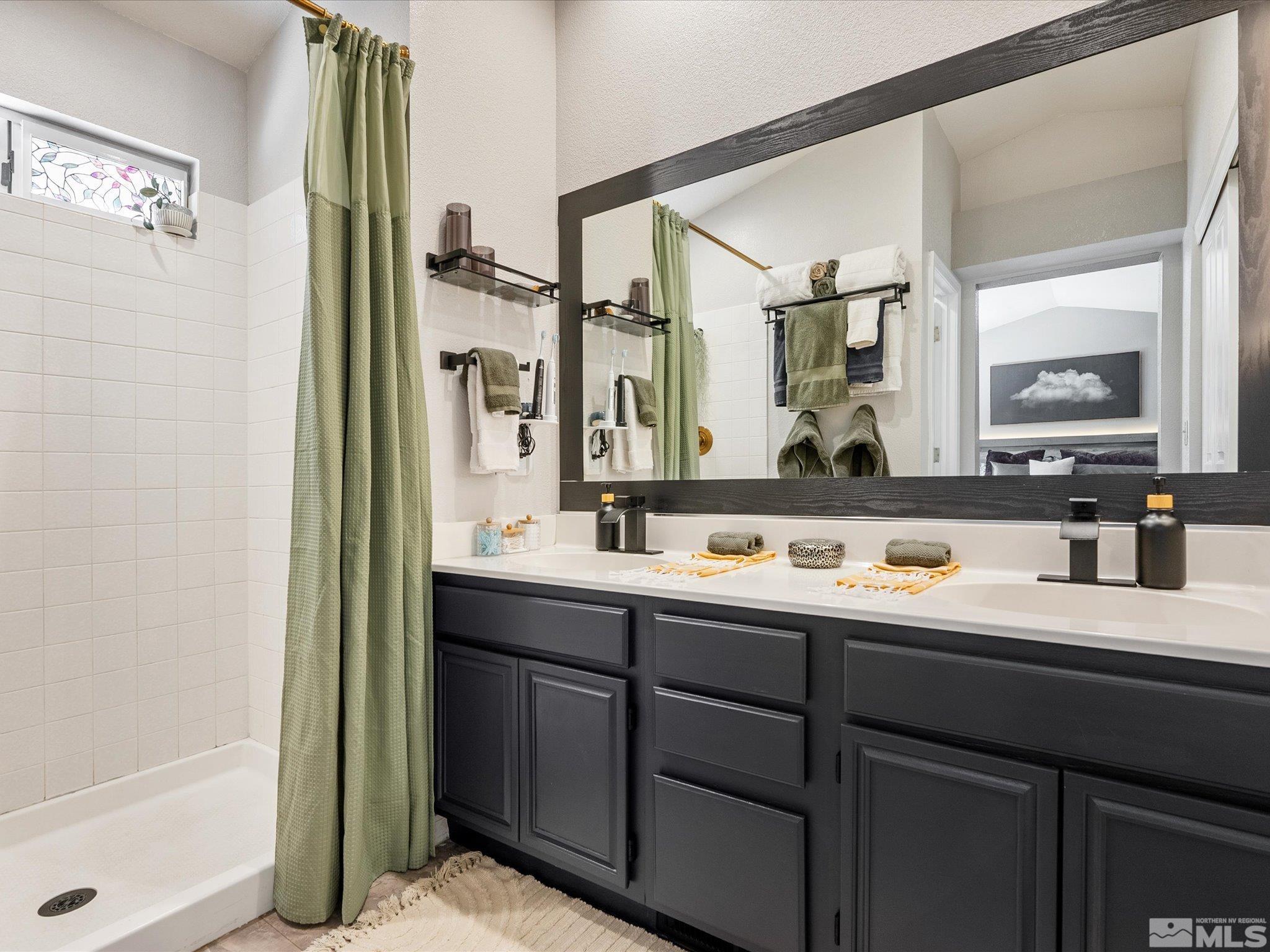 2946 Aspendale Drive Reno, NV 89503 - Photo 18 of 40 a bathroom with a double vanity sink mirror and bathtub