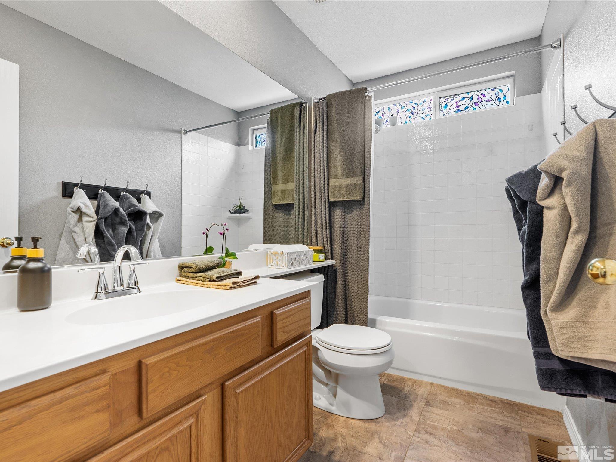 2946 Aspendale Drive Reno, NV 89503 - Photo 20 of 40 a bathroom with a granite countertop sink toilet and shower
