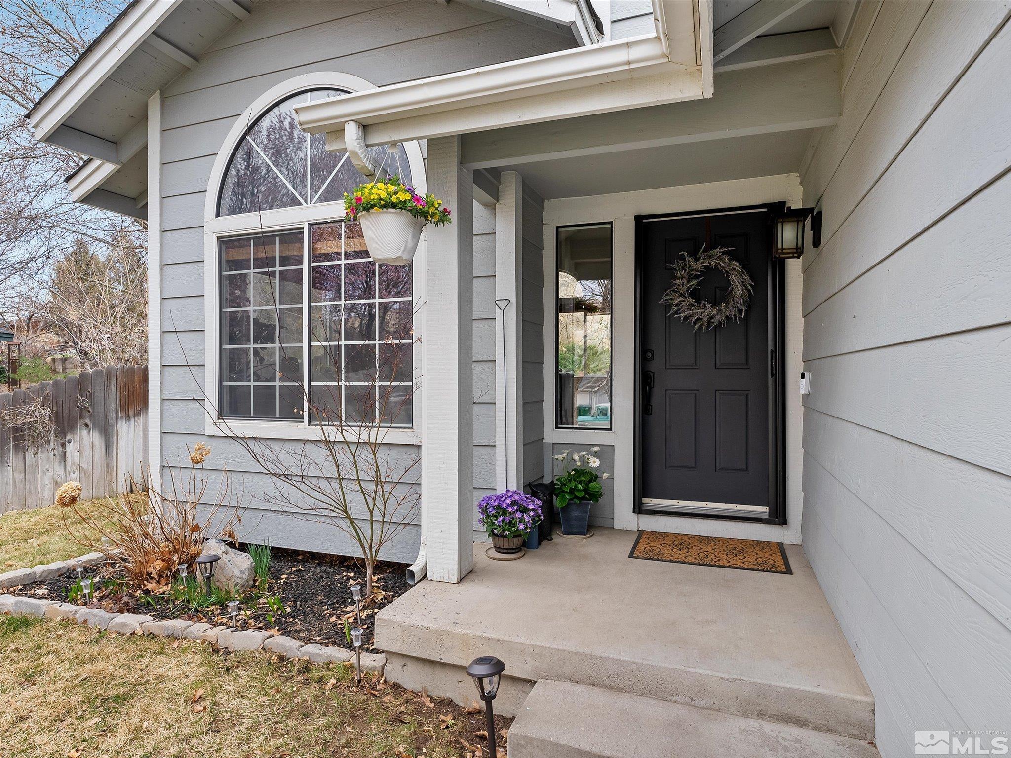 2946 Aspendale Drive Reno, NV 89503 - Photo 2 of 40 a front view of a house with a potted plant and garage