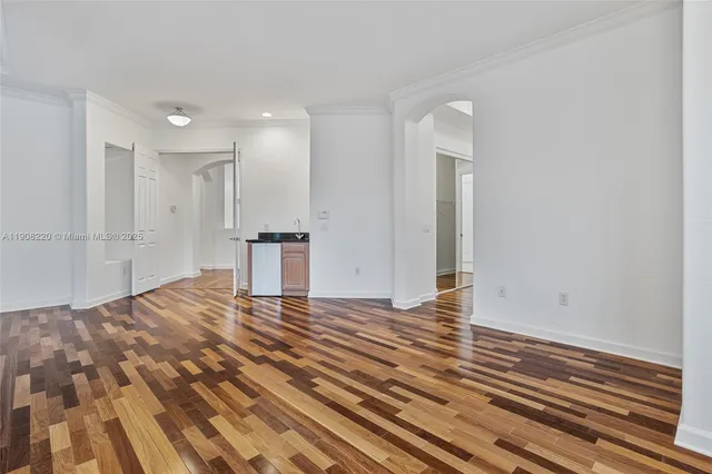 a view of empty room with wooden floor