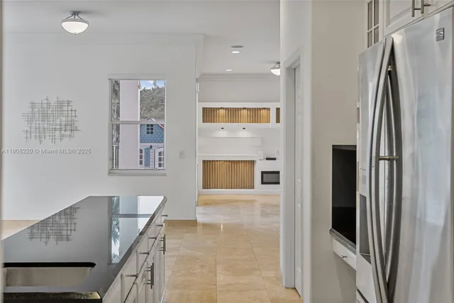 a view of kitchen with furniture and refrigerator