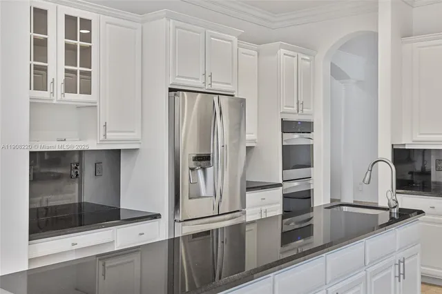 a kitchen with stainless steel appliances a refrigerator sink and cabinets