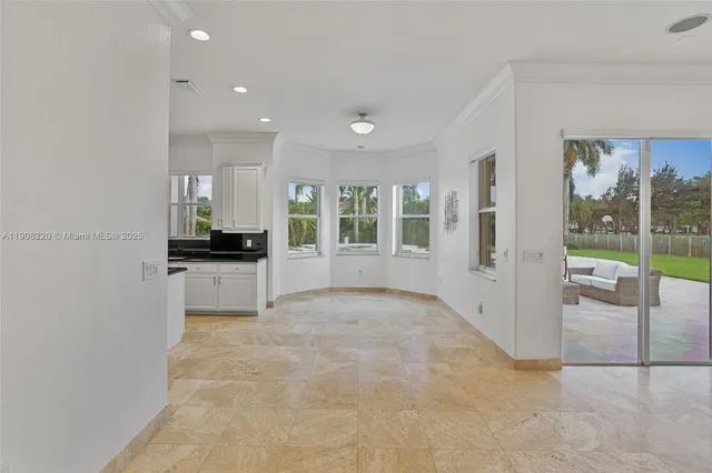a view of kitchen with refrigerator and windows