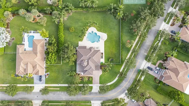 an aerial view of a house with a swimming pool