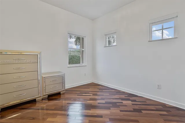a view of a hardwood floor and cabinet in a room