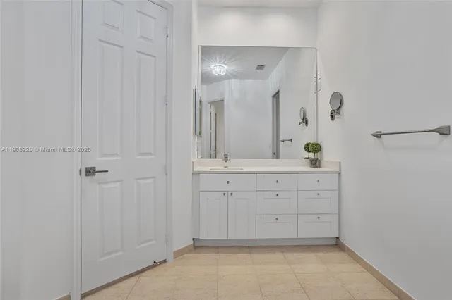 a spacious bathroom with a mirror and a shower