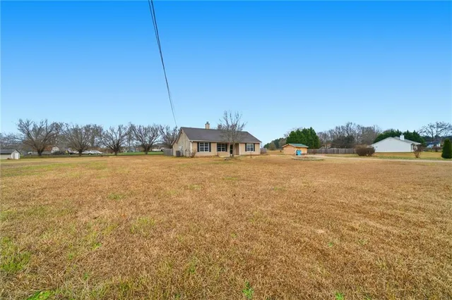 a view of yard with swimming pool and trees
