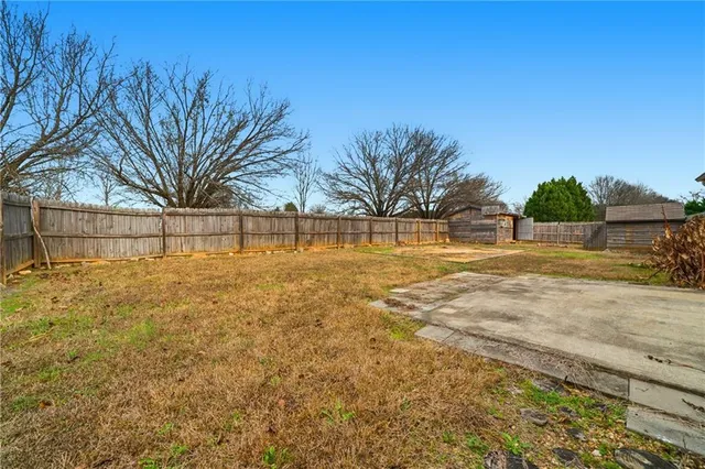 a view of yard with swimming pool and seating area