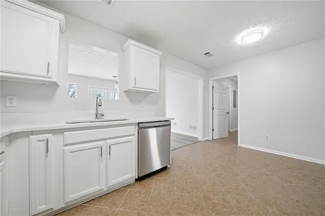 a kitchen with white cabinets