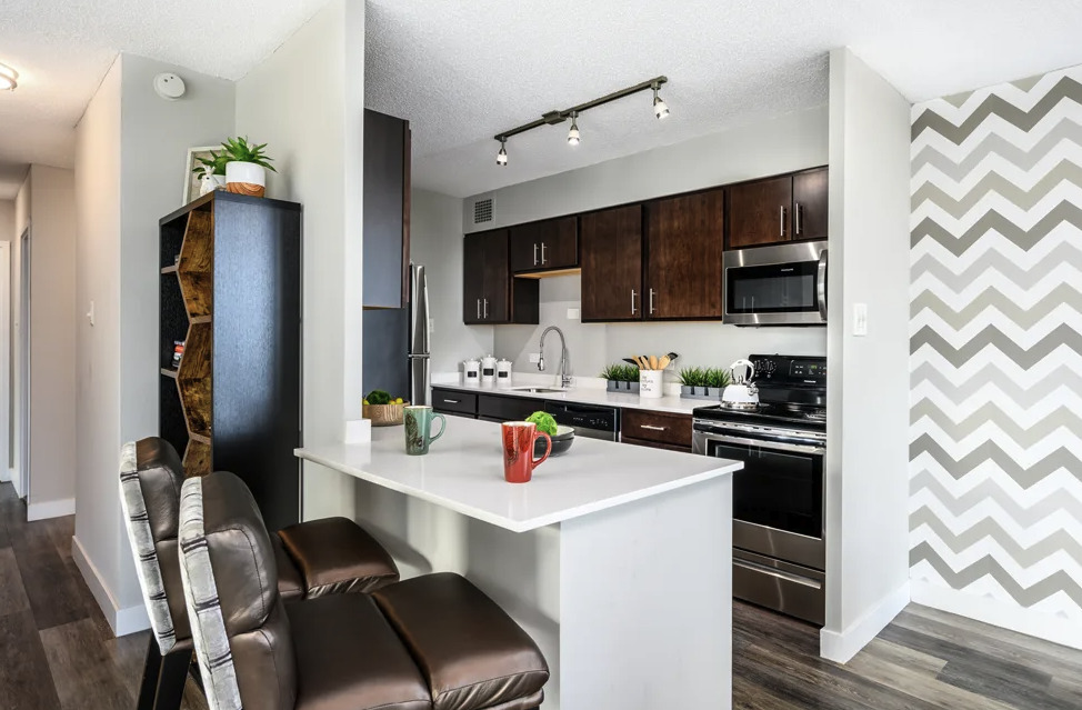 5600 North Sheridan Road, Unit 4A Chicago, IL 60660 - Photo 3 of 14 a kitchen with stainless steel appliances a stove a sink and a refrigerator