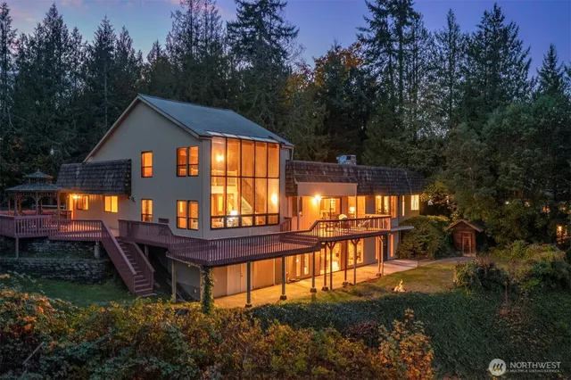 a front view of a house with balcony and garden