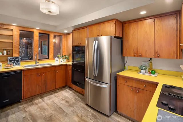 a kitchen with sink refrigerator and cabinets