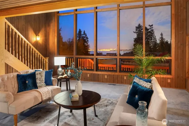 a living room with furniture and a floor to ceiling window
