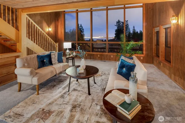 a living room with furniture and a floor to ceiling window